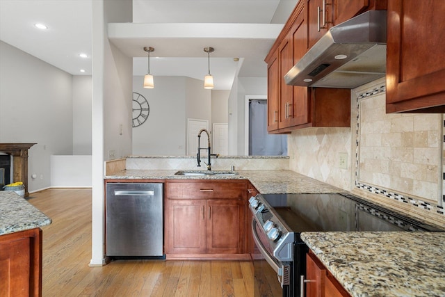 9701 W Masters Ln, Cheney, WA 99004 - kitchen with under cabinet range hood, appliances with stainless steel finishes, light wood-type flooring, tasteful backsplash, and recessed lighting
