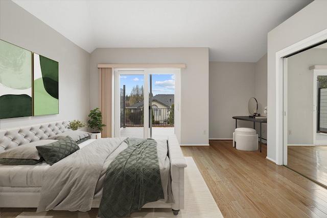 9701 W Masters Ln, Cheney, WA 99004 - bedroom featuring access to exterior, vaulted ceiling, and light wood-style flooring