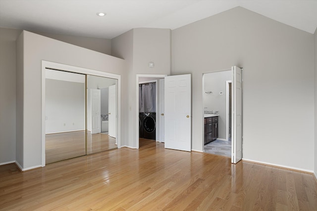 9701 W Masters Ln, Cheney, WA 99004 - unfurnished bedroom with washer / clothes dryer, high vaulted ceiling, light wood-style flooring, a closet, and connected bathroom