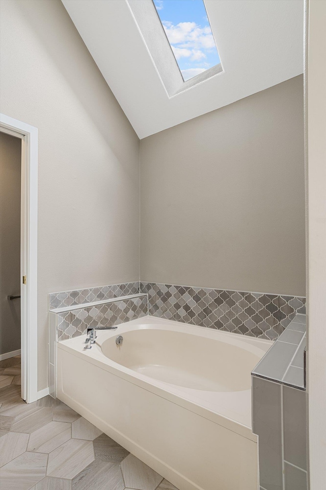 9701 W Masters Ln, Cheney, WA 99004 - bathroom with a skylight, a garden tub, and tile patterned flooring