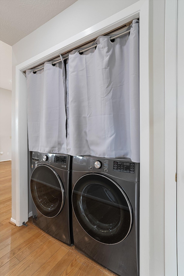 9701 W Masters Ln, Cheney, WA 99004 - laundry area featuring light wood-style flooring and independent washer and dryer