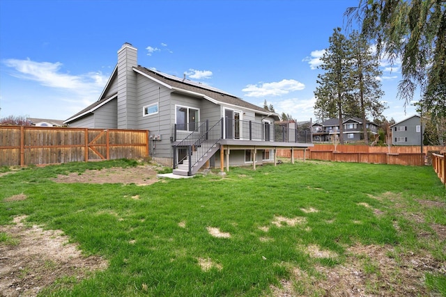 9701 W Masters Ln, Cheney, WA 99004 - back of property with stairs, a fenced backyard, a wooden deck, and a chimney