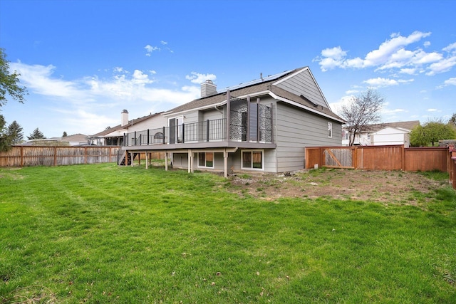 9701 W Masters Ln, Cheney, WA 99004 - rear view of house with stairway, a fenced backyard, a wooden deck, a chimney, and solar panels