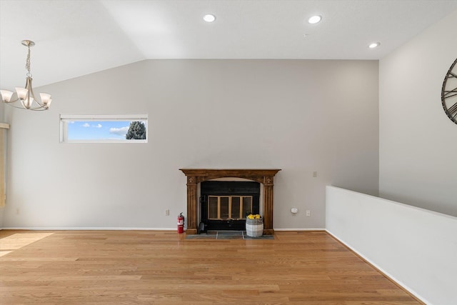 9701 W Masters Ln, Cheney, WA 99004 - unfurnished living room with a chandelier, vaulted ceiling, wood finished floors, recessed lighting, and a fireplace with flush hearth