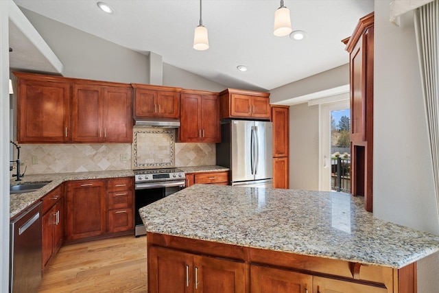 9701 W Masters Ln, Cheney, WA 99004 - kitchen with appliances with stainless steel finishes, vaulted ceiling, light wood-type flooring, tasteful backsplash, and under cabinet range hood