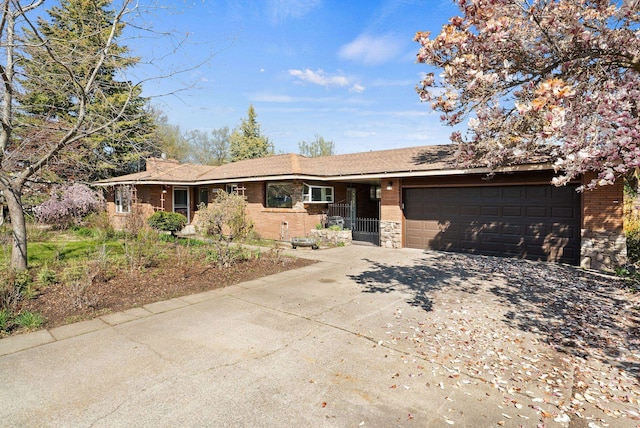 ranch-style house featuring an attached garage, driveway, and brick siding