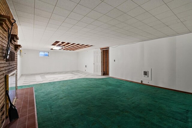 basement with a fireplace and carpet