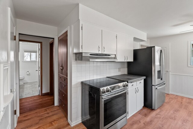 kitchen featuring under cabinet range hood, white cabinets, appliances with stainless steel finishes, and light wood finished floors