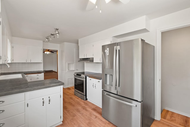 kitchen featuring white cabinets, a ceiling fan, stainless steel appliances, and a sink