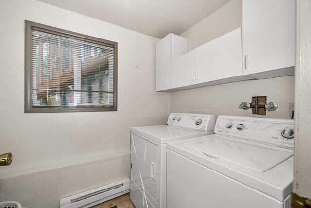 laundry room with cabinet space, independent washer and dryer, and baseboard heating