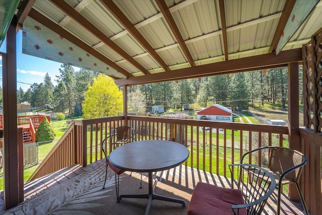 wooden terrace featuring a lawn