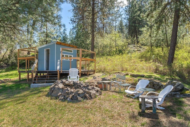 view of yard with a wooden deck and an outdoor structure