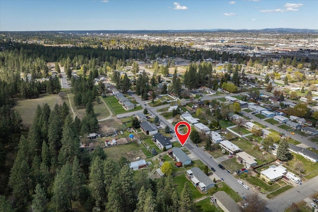 aerial view featuring a forest view and a residential view
