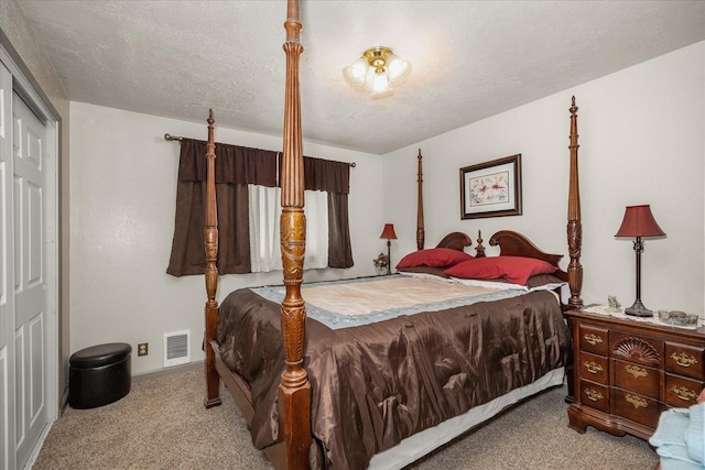 bedroom with a textured ceiling, baseboards, visible vents, a closet, and carpet floors