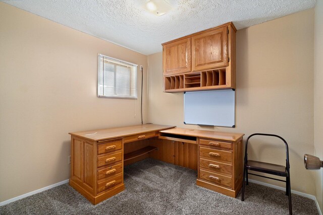 unfurnished office with baseboards, dark colored carpet, and a textured ceiling