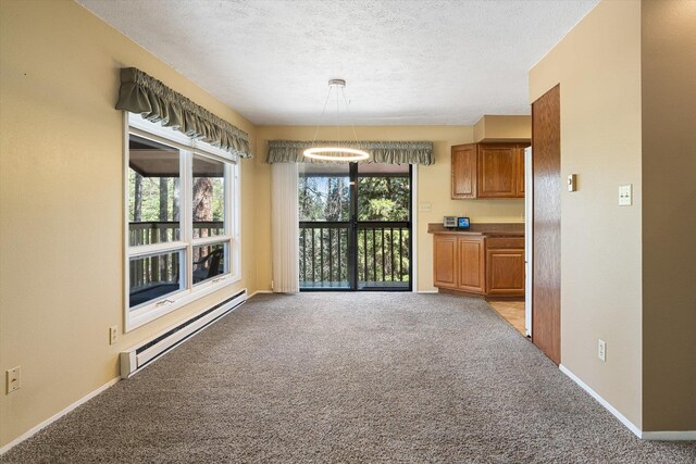interior space featuring a baseboard radiator, baseboards, a textured ceiling, and carpet