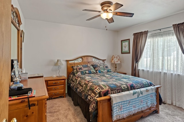 bedroom with light carpet and ceiling fan