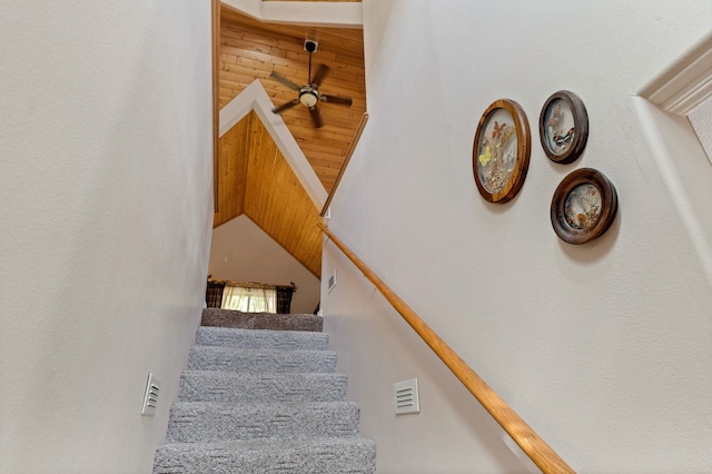 stairs featuring a ceiling fan