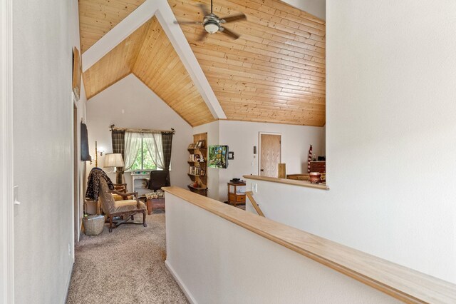 hall with vaulted ceiling, wood ceiling, light carpet, and an upstairs landing