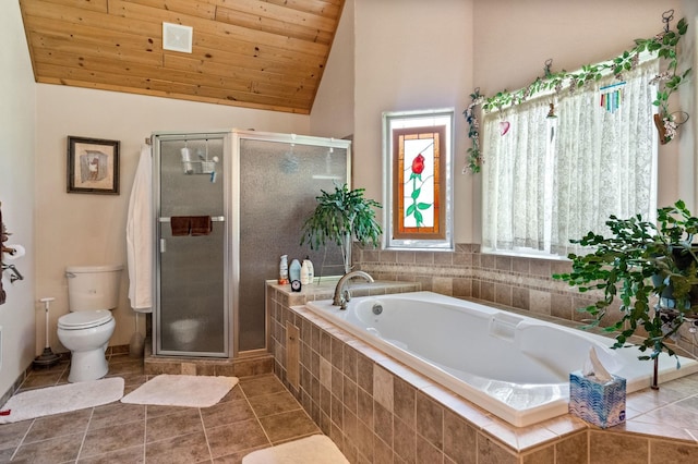 bathroom featuring vaulted ceiling, toilet, a stall shower, and tile patterned floors
