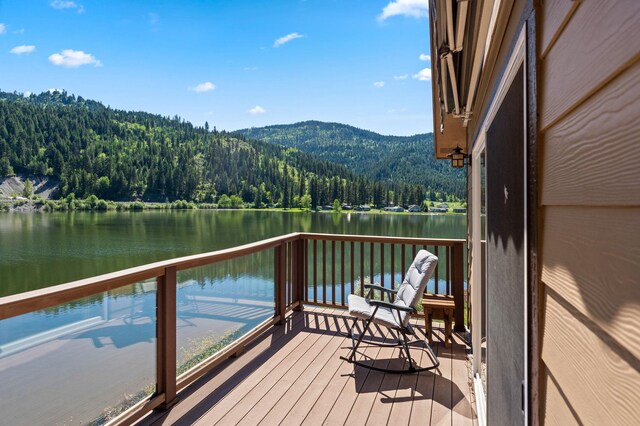 exterior space featuring a view of trees and a water and mountain view