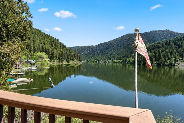 view of water feature with a forest view and a mountain view