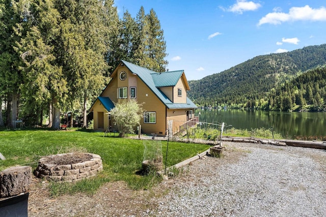 2876 Deep Lake S Shore Rd, Colville, WA 99114 - view of home's exterior with a wooded view, a water and mountain view, a yard, and a metal roof