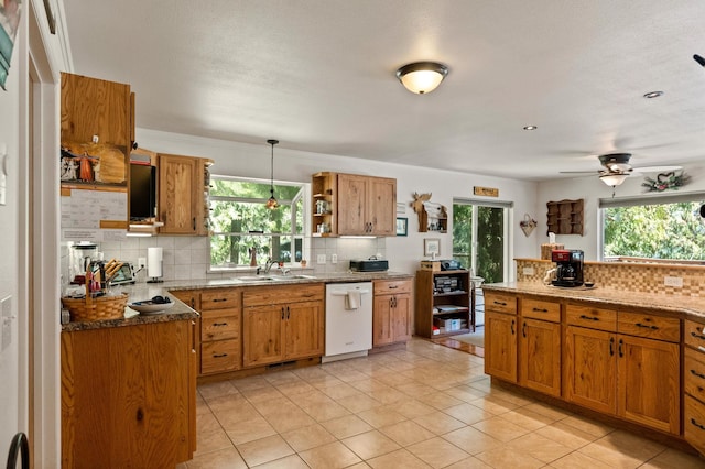 kitchen featuring dishwasher, decorative backsplash, open shelves, and brown cabinetry