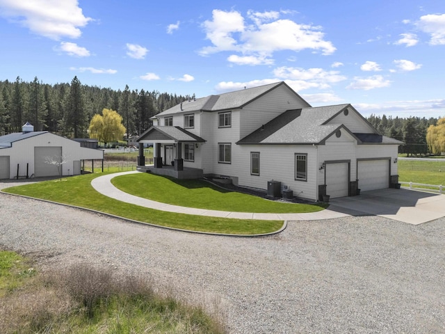 4127 S Sullivan Rd, Veradale, WA 99037 - view of front of home featuring a shingled roof, central AC, driveway, a view of trees, and a front yard