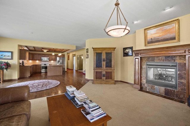 4127 S Sullivan Rd, Veradale, WA 99037 - living area with baseboards, dark wood-style flooring, and a tile fireplace