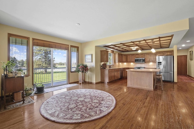 4127 S Sullivan Rd, Veradale, WA 99037 - kitchen featuring a center island, appliances with stainless steel finishes, light countertops, coffered ceiling, and dark wood-style flooring