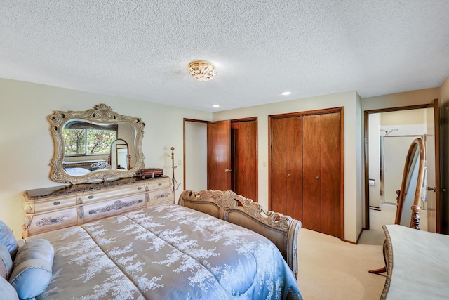 bedroom with light carpet, multiple closets, a textured ceiling, and recessed lighting