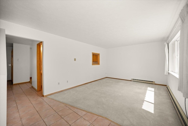 unfurnished room featuring a baseboard heating unit, baseboards, baseboard heating, and light colored carpet