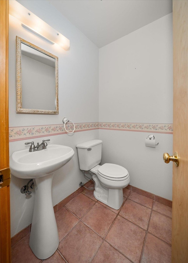 bathroom featuring tile patterned flooring and toilet