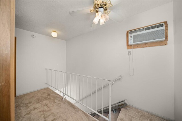 stairs with a wall mounted air conditioner, ceiling fan, and carpet floors
