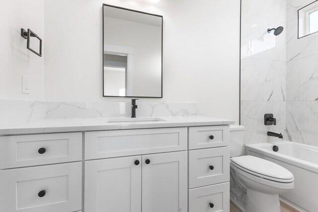 bathroom with shower / bath combination, vanity, and toilet