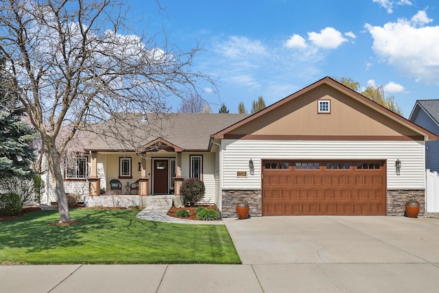 craftsman inspired home with stone siding, concrete driveway, covered porch, a garage, and a front yard