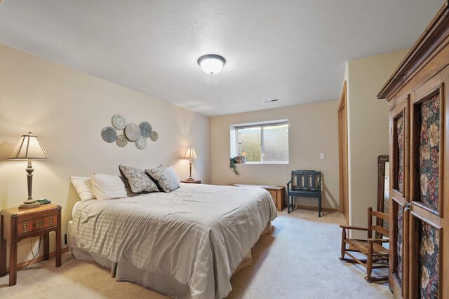 bedroom featuring light carpet and baseboards