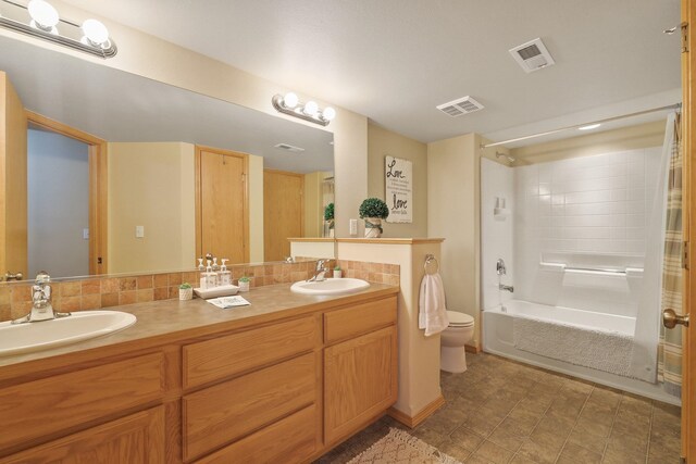full bath with toilet, a sink, and visible vents
