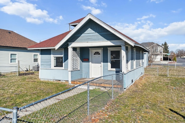 shotgun-style home with a fenced backyard, central AC unit, and a front yard