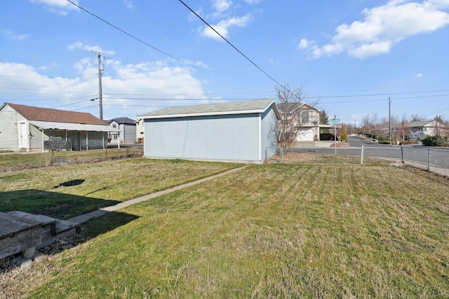 view of yard featuring an outdoor structure and fence