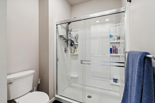 18706 E Flat Rock River Ave, Spokane Valley, WA 99016 - bathroom featuring toilet, a textured wall, and a stall shower