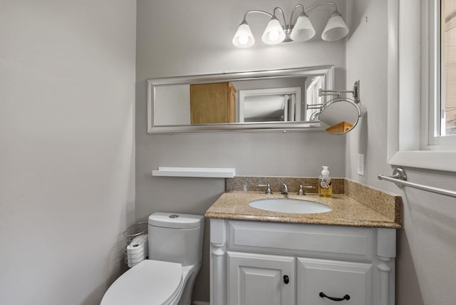 bathroom with toilet and vanity