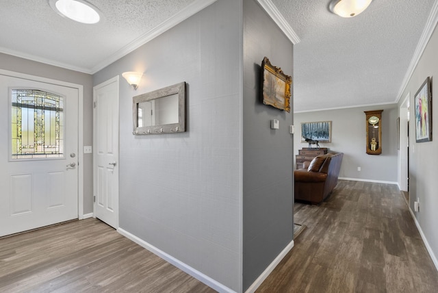foyer entrance with baseboards, crown molding, wood finished floors, and a textured ceiling