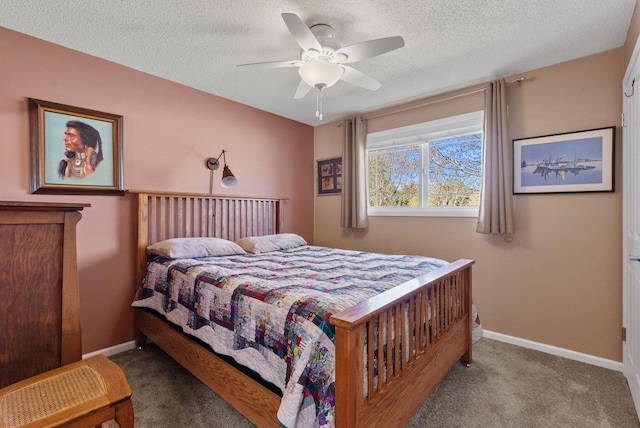 carpeted bedroom featuring a textured ceiling, a ceiling fan, and baseboards