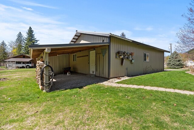 view of home's exterior featuring a lawn, driveway, and a carport