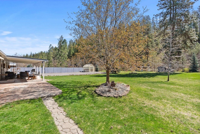 view of yard featuring fence and a patio