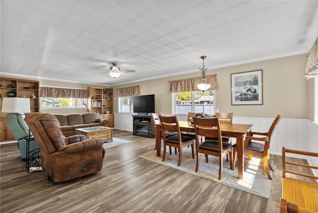 dining space featuring a ceiling fan, wood finished floors, and a wealth of natural light