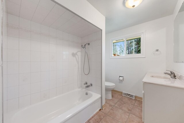 bathroom featuring toilet, baseboards, visible vents, washtub / shower combination, and vanity