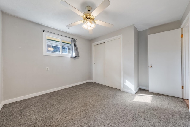 unfurnished bedroom with baseboards, carpet floors, a ceiling fan, and a closet